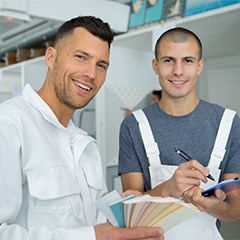 A pair of house painters smiling