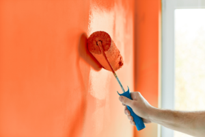 a homeowner painting an interior accent wall