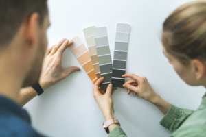 a homeowner examining paint samples before painting